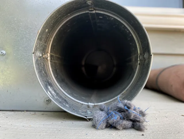 Cuyahoga Falls Dryer Vent Cleaning technician using specialized equipment to clear severe dryer vent blockage in Cuyahoga Falls